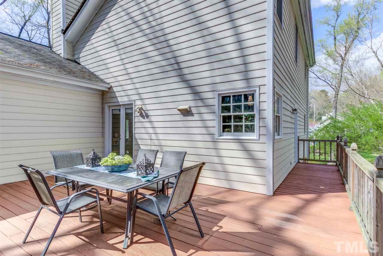 6908 Spring Drive Raleigh, NC 27613 - Photo 25 of 30 a view of patio with table and chairs and potted plants