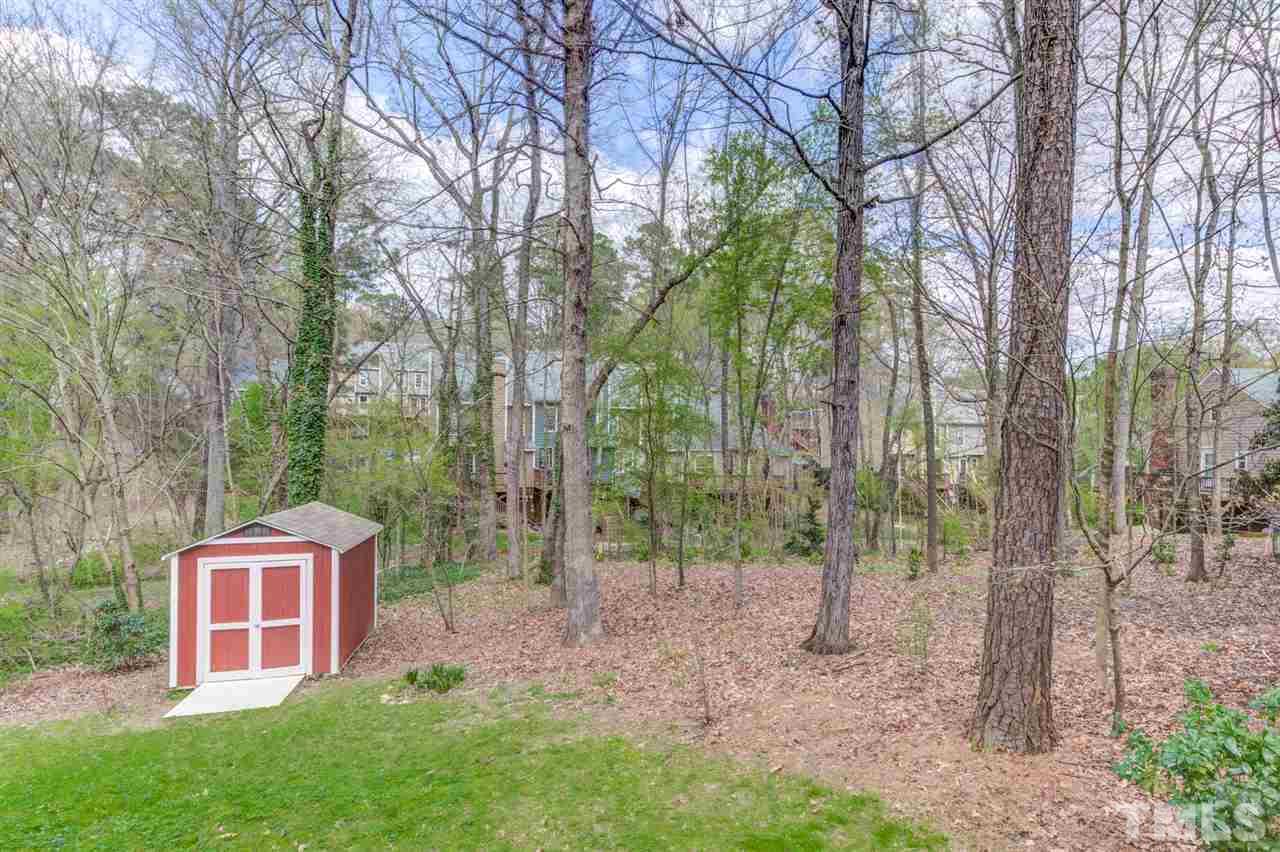6908 Spring Drive Raleigh, NC 27613 - Photo 28 of 30 a red brick house with trees in front of it