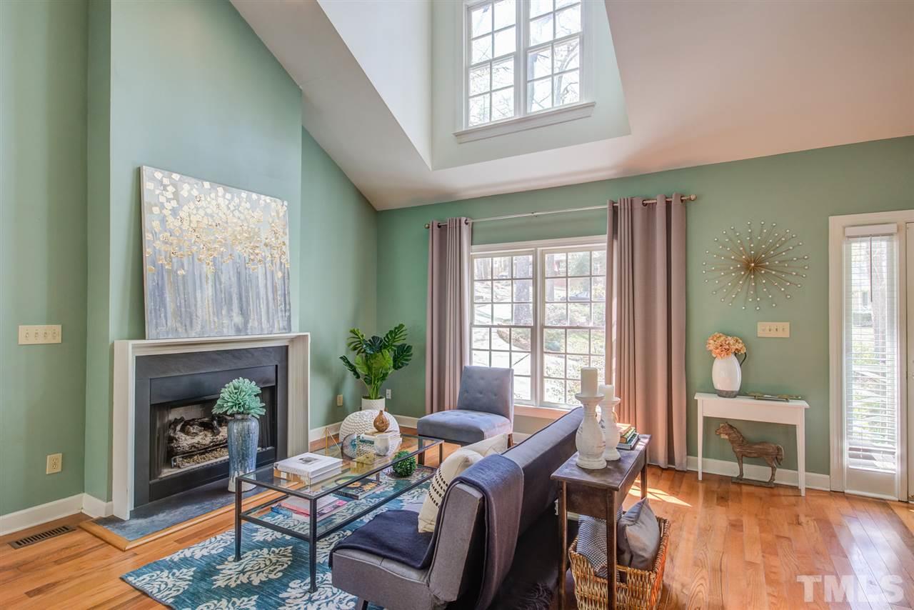 6908 Spring Drive Raleigh, NC 27613 - Photo 6 of 30 a living room with furniture a fireplace and a table