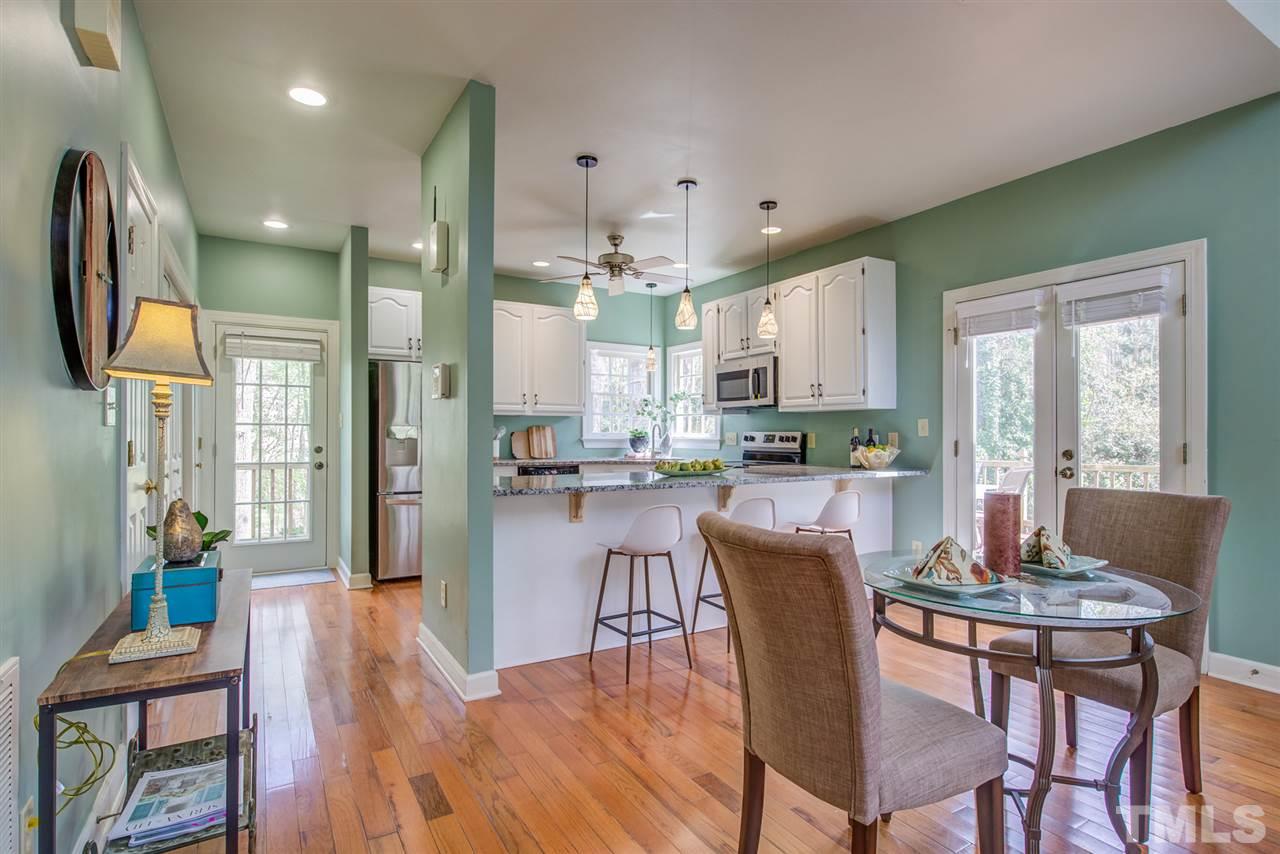 6908 Spring Drive Raleigh, NC 27613 - Photo 9 of 30 a view of a dining room with furniture large window and wooden floor