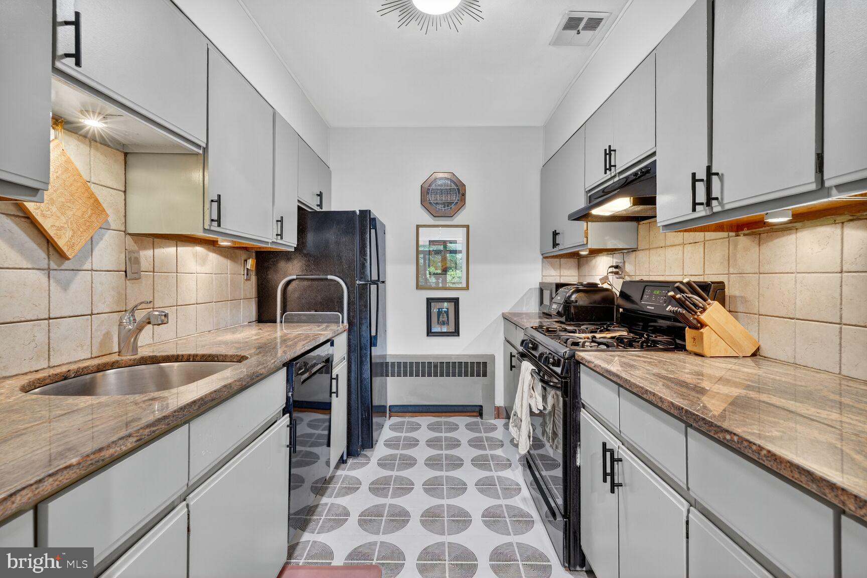 333 N Street Southwest, Unit 333 Washington, DC 20024 - Photo 8 of 20 a kitchen with stainless steel appliances granite countertop a sink stove and cabinets