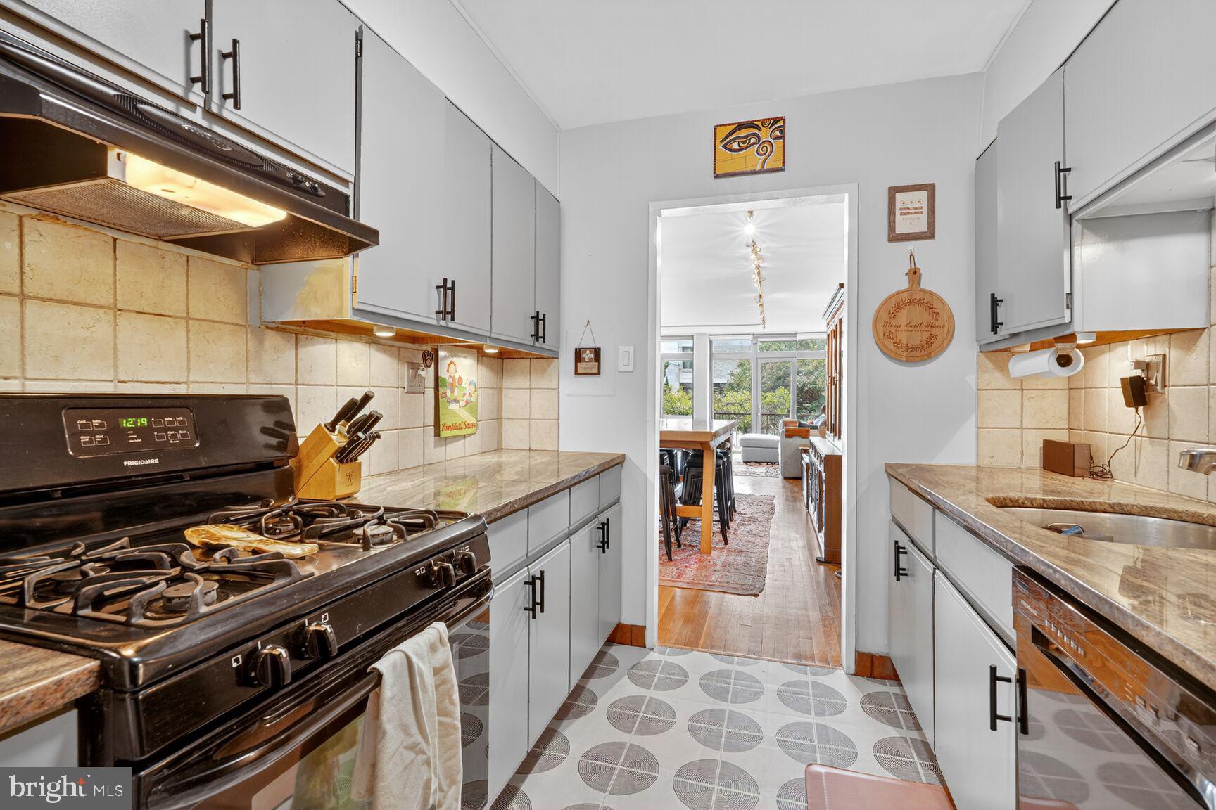 333 N Street Southwest, Unit 333 Washington, DC 20024 - Photo 10 of 20 a kitchen with stainless steel appliances granite countertop a stove and a sink