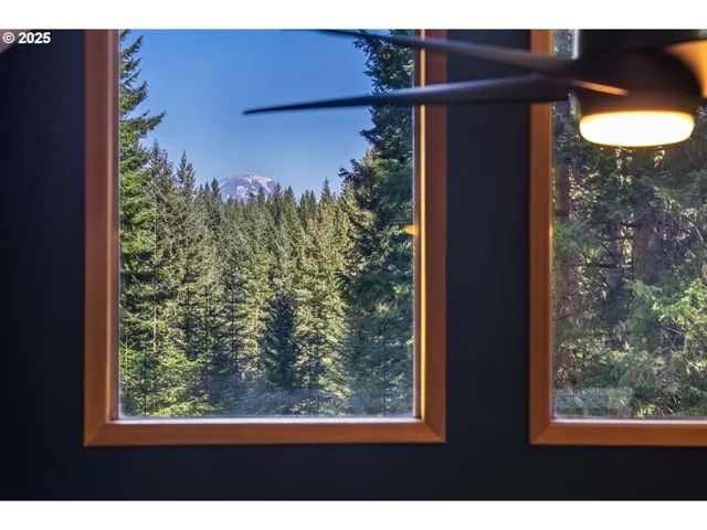 a bedroom with furniture and a large window