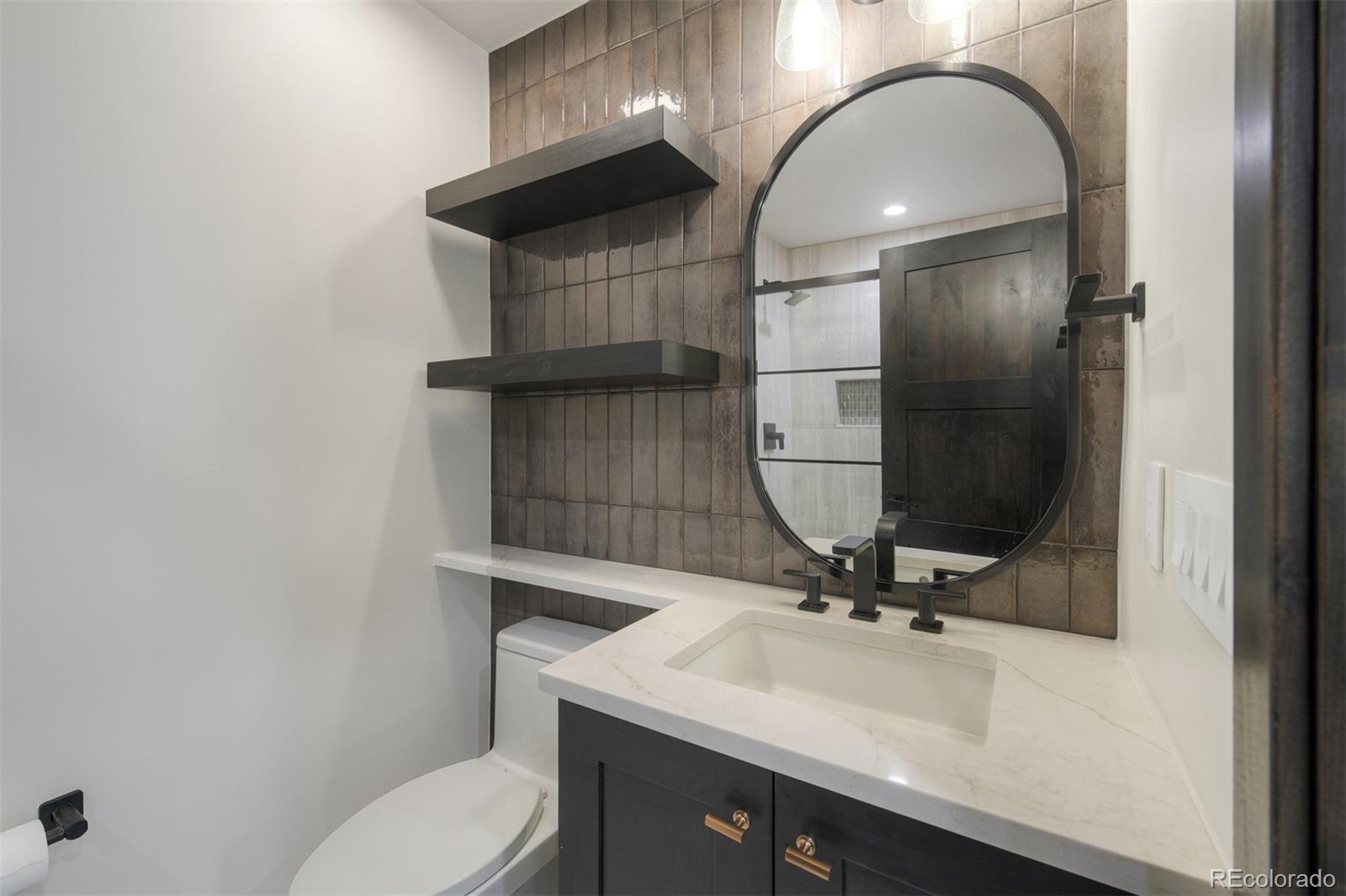 306 Golden Eagle Road Silverthorne, CO 80498 - Photo 17 of 43 a bathroom with a sink a toilet and a mirror