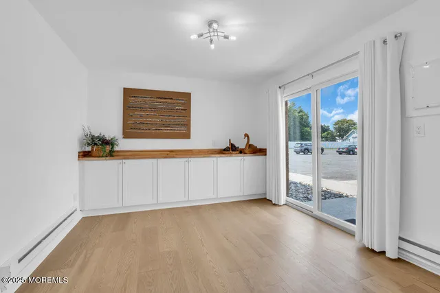 a view of a room with cabinet and mirrors