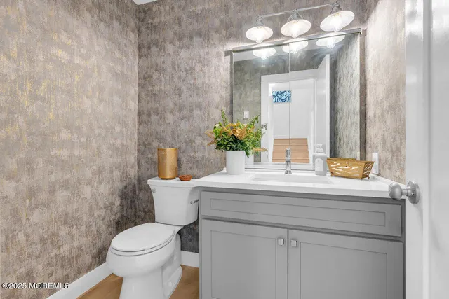 a kitchen with granite countertop white cabinets and stainless steel appliances