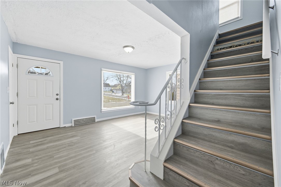 20705 Hansen Road Maple Heights, OH 44137 - Photo 5 of 24 Entrance foyer featuring stairs and light wood-style floors
