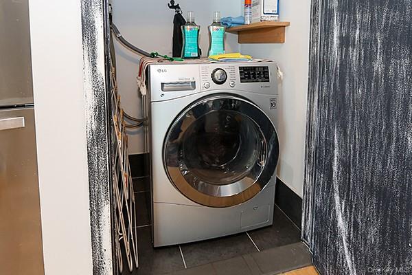 63-34 Fresh Pond Road, Unit 5C Queens, NY 11385 - Photo 14 of 29 Washroom with washer / clothes dryer and light tile patterned flooring