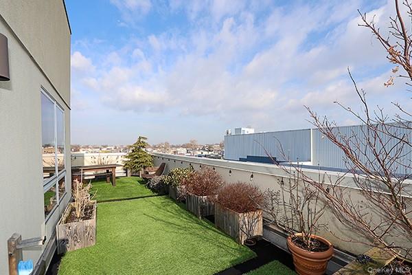 63-34 Fresh Pond Road, Unit 5C Queens, NY 11385 - Photo 16 of 29 View of green lawn featuring a patio area