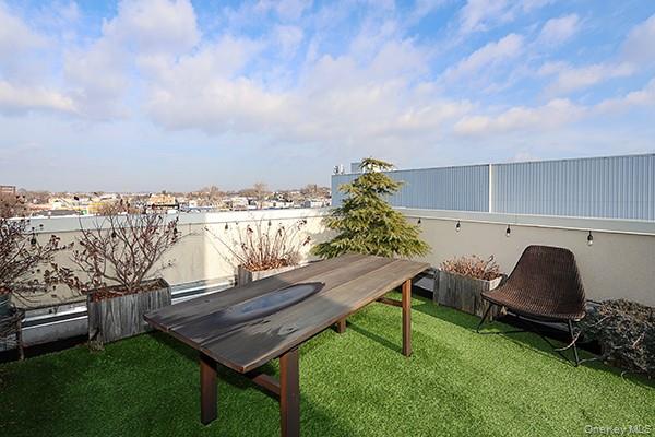 63-34 Fresh Pond Road, Unit 5C Queens, NY 11385 - Photo 19 of 29 View of green lawn with a patio