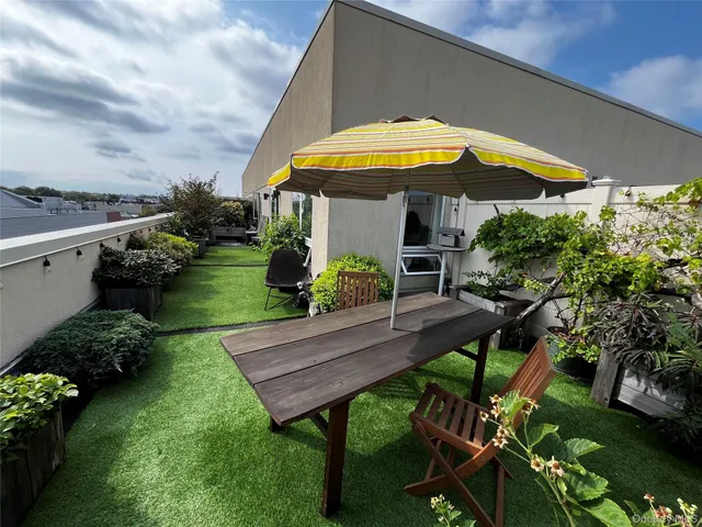 a view of a backyard with sitting area