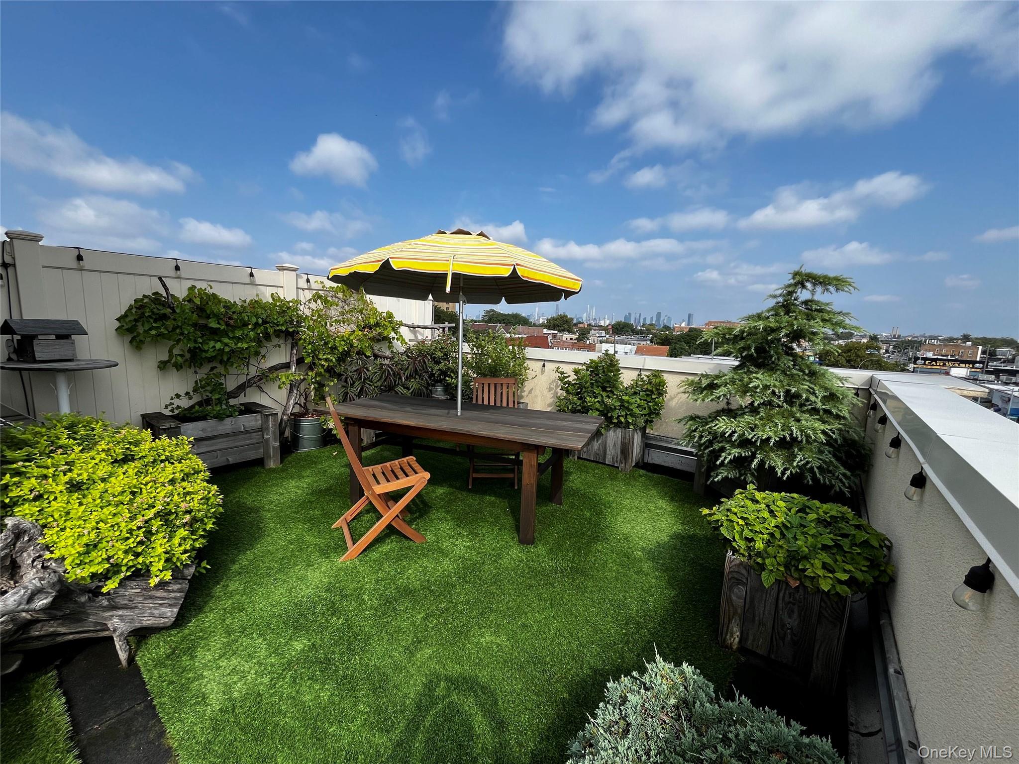 63-34 Fresh Pond Road, Unit 5C Queens, NY 11385 - Photo 23 of 29 View of grassy yard with a patio area