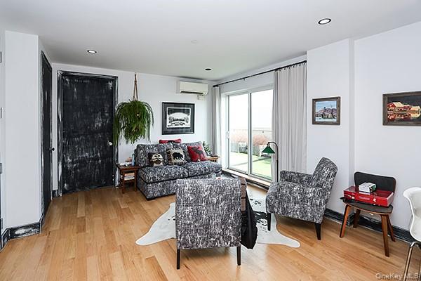 63-34 Fresh Pond Road, Unit 5C Queens, NY 11385 - Photo 5 of 29 Living room featuring light wood-style flooring, a wall mounted air conditioner, and recessed lighting
