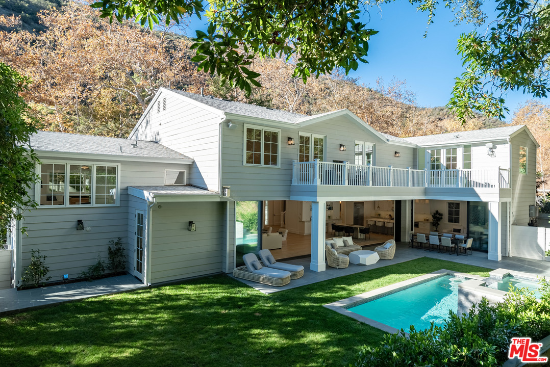 a view of a house with a yard porch and sitting area