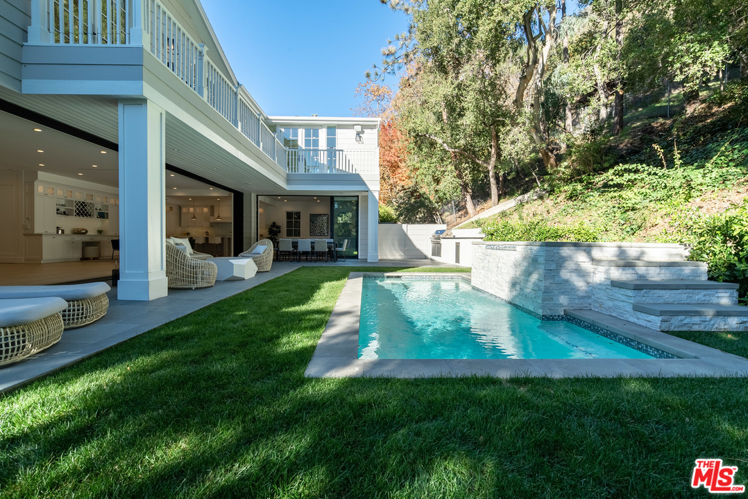 2794 Mandeville Canyon Road Los Angeles, CA 90049 - Photo 11 of 18 a view of a house with a yard porch and sitting area