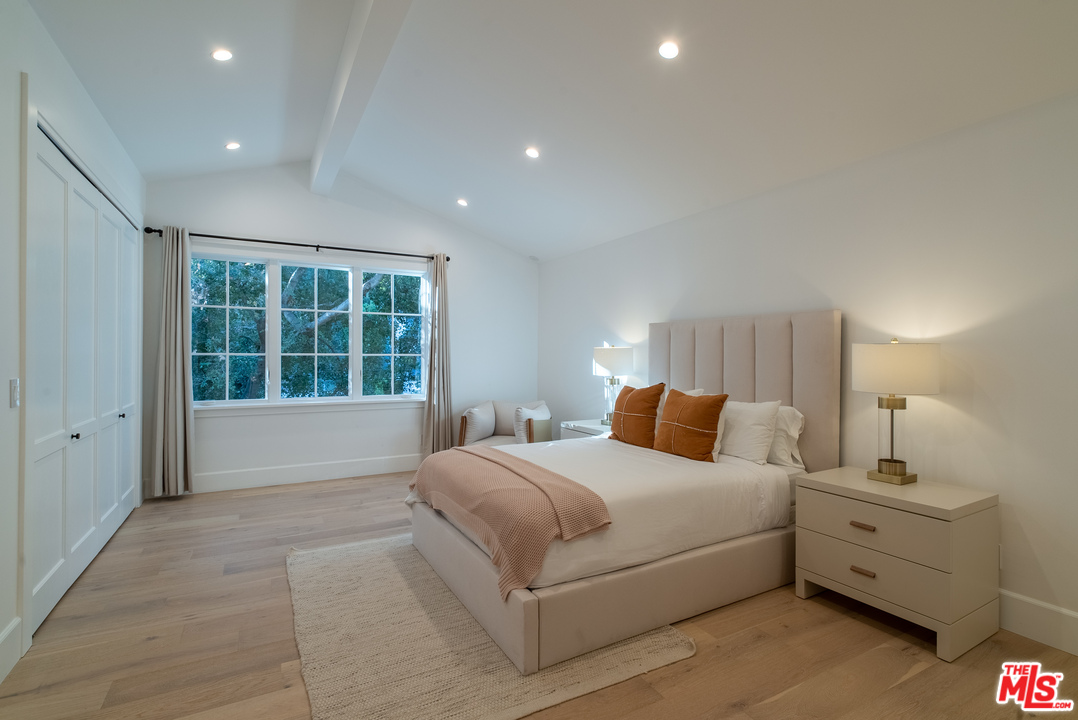 2794 Mandeville Canyon Road Los Angeles, CA 90049 - Photo 16 of 18 a bedroom with a large bed and a window