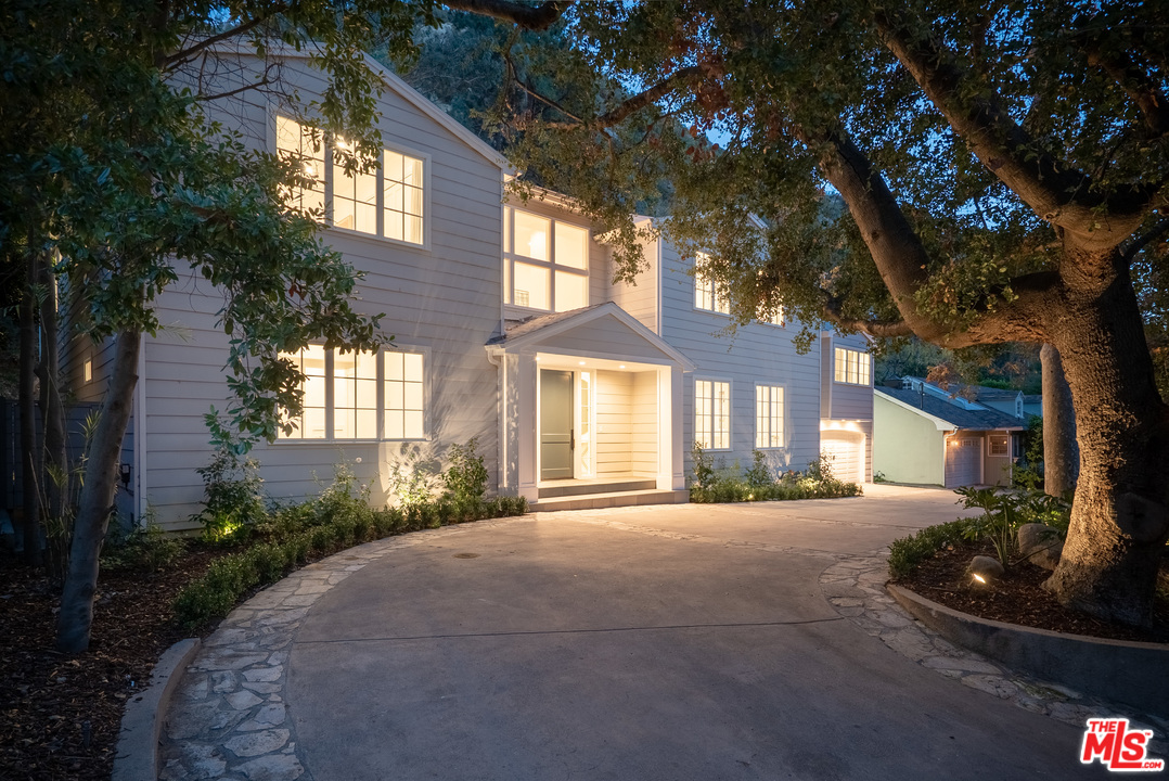2794 Mandeville Canyon Road Los Angeles, CA 90049 - Photo 18 of 18 a front view of a house with a yard and garage