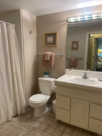 a bedroom with a bed and a lamp