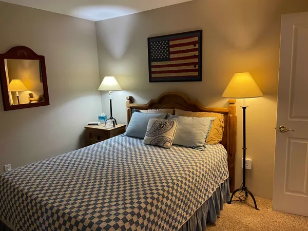 a bedroom with a bed and a lamp