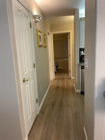 a bedroom with a bed and a lamp on dresser