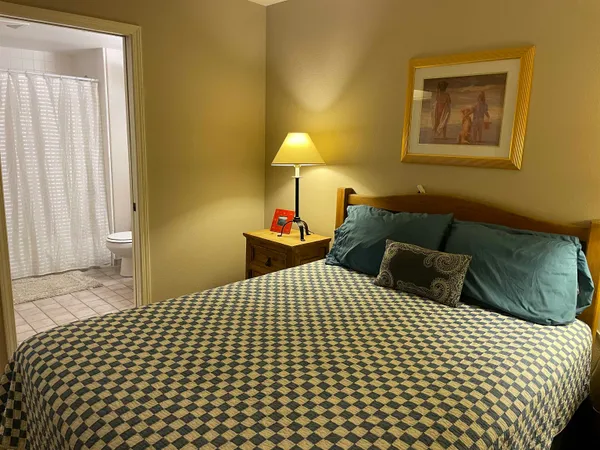 a bedroom with a bed and a lamp