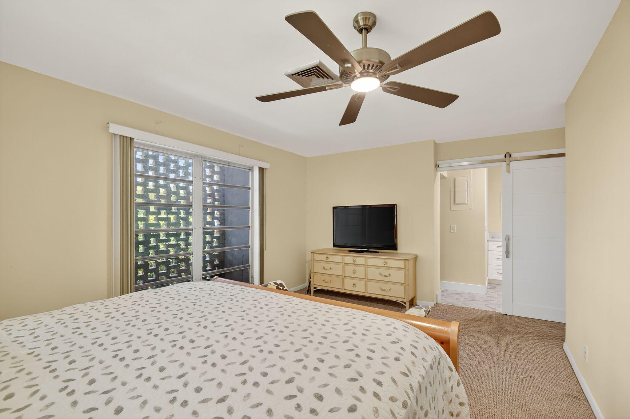 324 Orange Tree Drive, Unit 5 Atlantis, FL 33462 - Photo 11 of 29 a bedroom with a bed and a flat screen tv