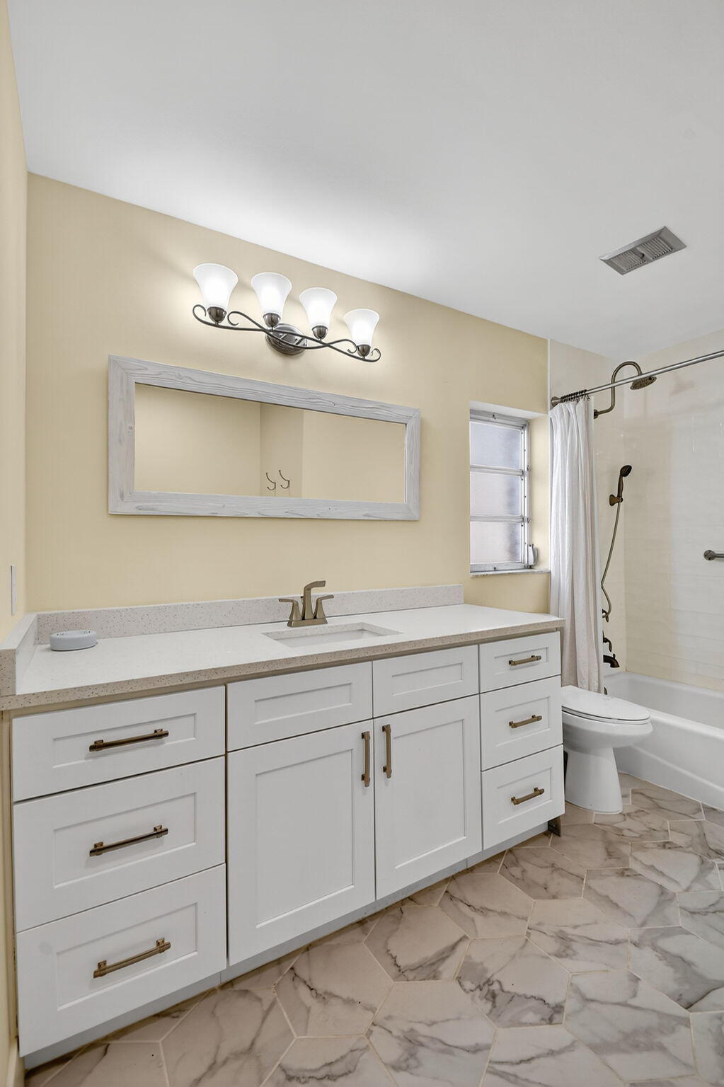 324 Orange Tree Drive, Unit 5 Atlantis, FL 33462 - Photo 12 of 29 a spacious bathroom with double sink and a mirror