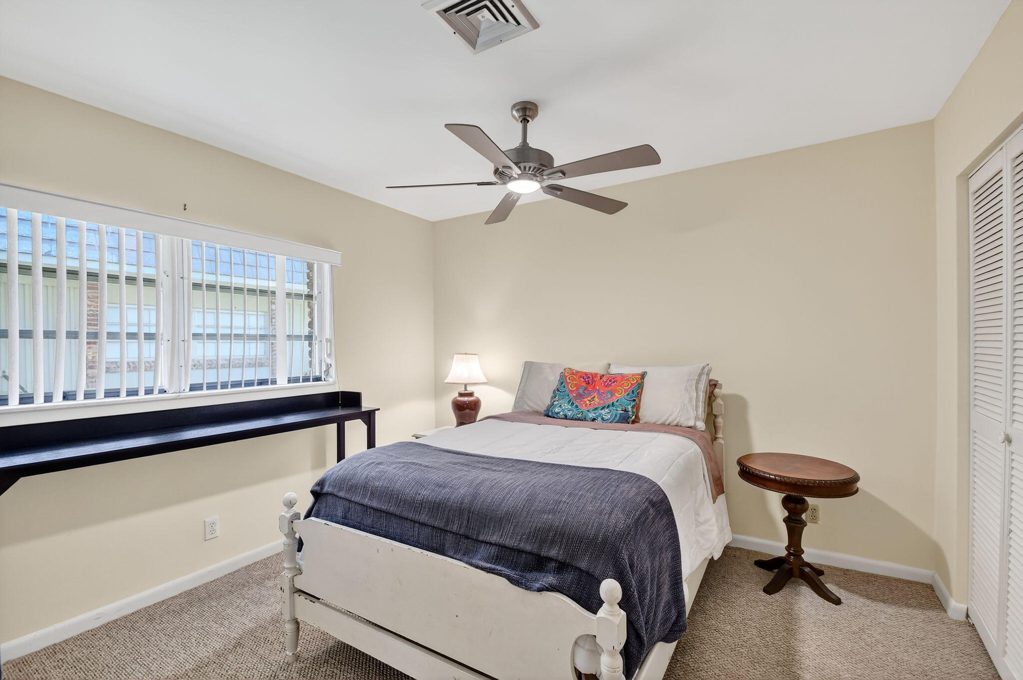 324 Orange Tree Drive, Unit 5 Atlantis, FL 33462 - Photo 14 of 29 a bedroom with a bed and window