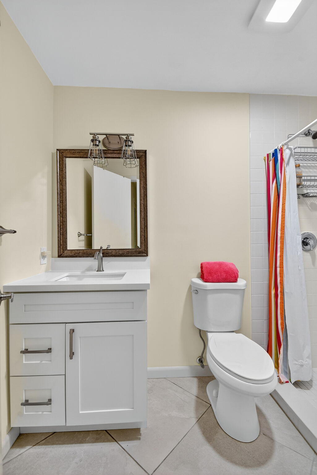324 Orange Tree Drive, Unit 5 Atlantis, FL 33462 - Photo 16 of 29 a bathroom with a toilet a sink and a mirror