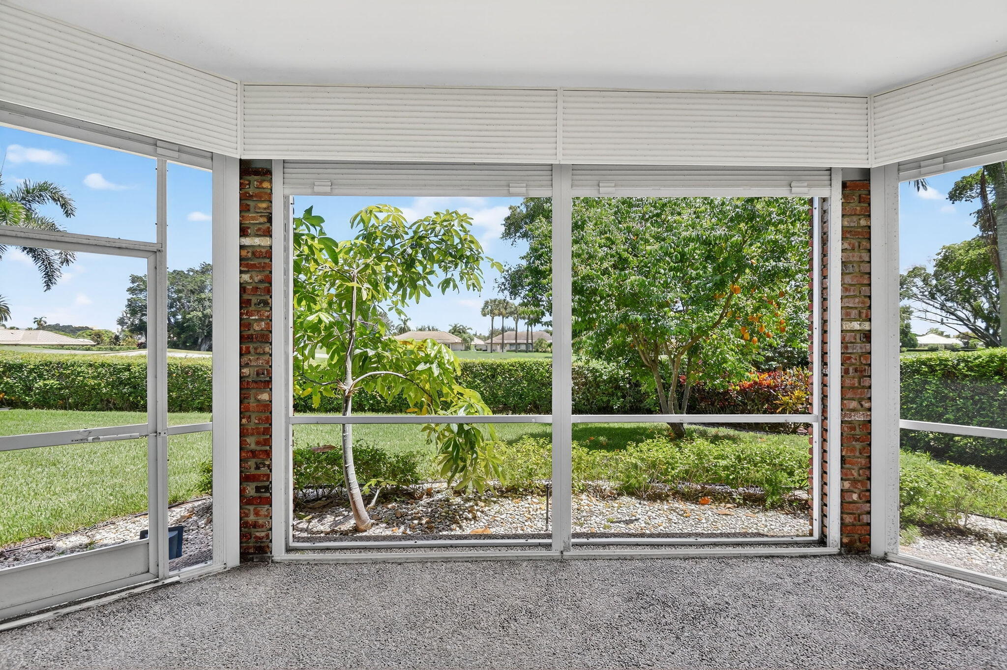 324 Orange Tree Drive, Unit 5 Atlantis, FL 33462 - Photo 18 of 29 a view of a garden with a floor to ceiling windows and yard
