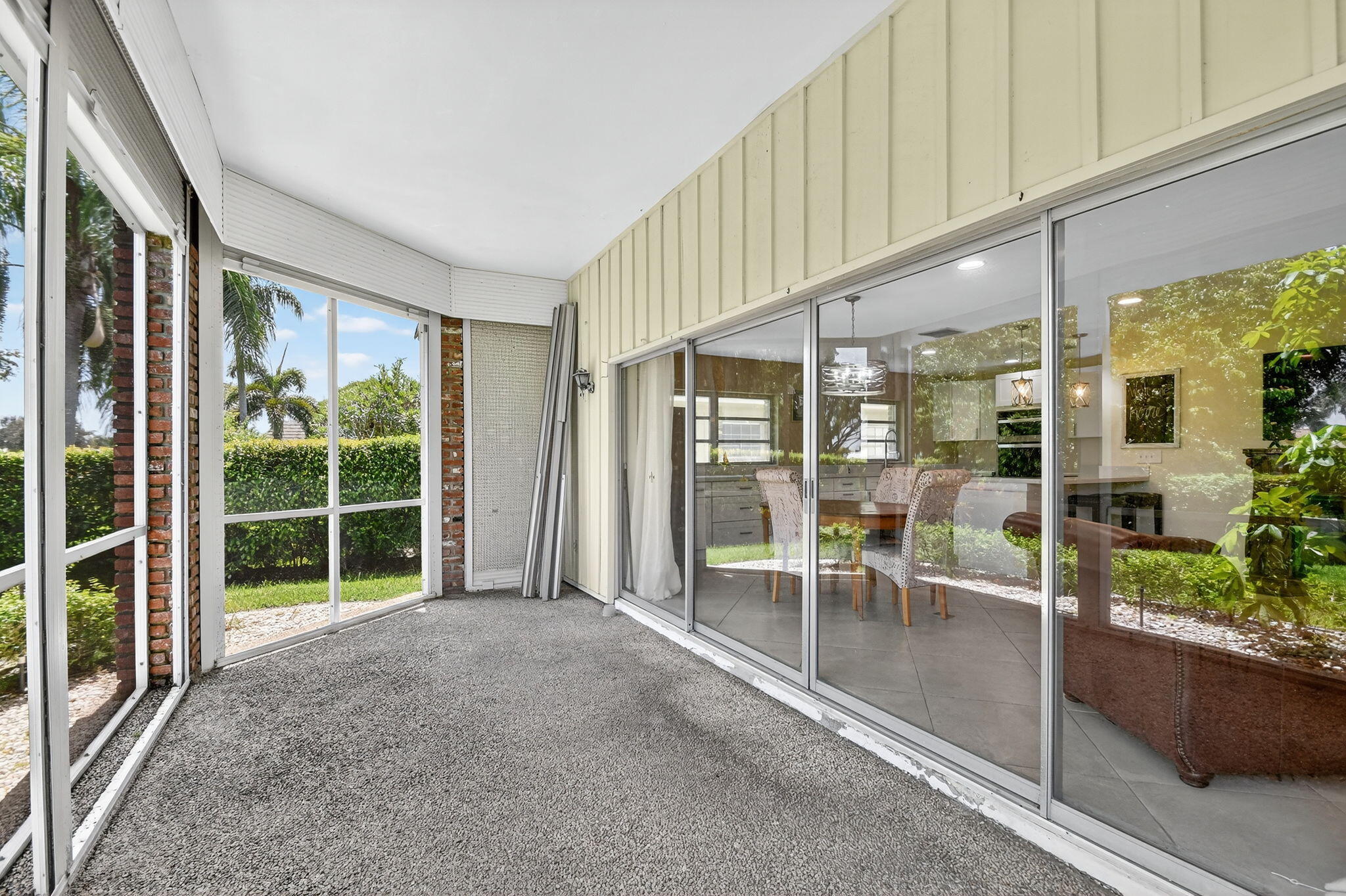 324 Orange Tree Drive, Unit 5 Atlantis, FL 33462 - Photo 19 of 29 a view of a porch with chairs and potted plants