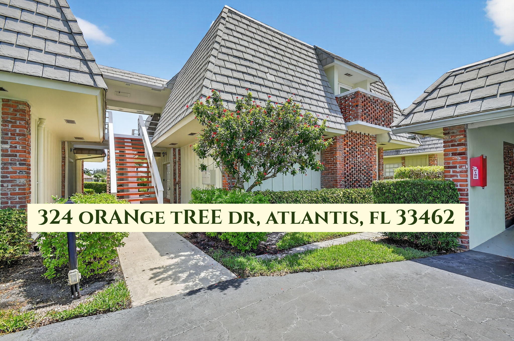 324 Orange Tree Drive, Unit 5 Atlantis, FL 33462 - Photo 2 of 29 a sign on the side of a building