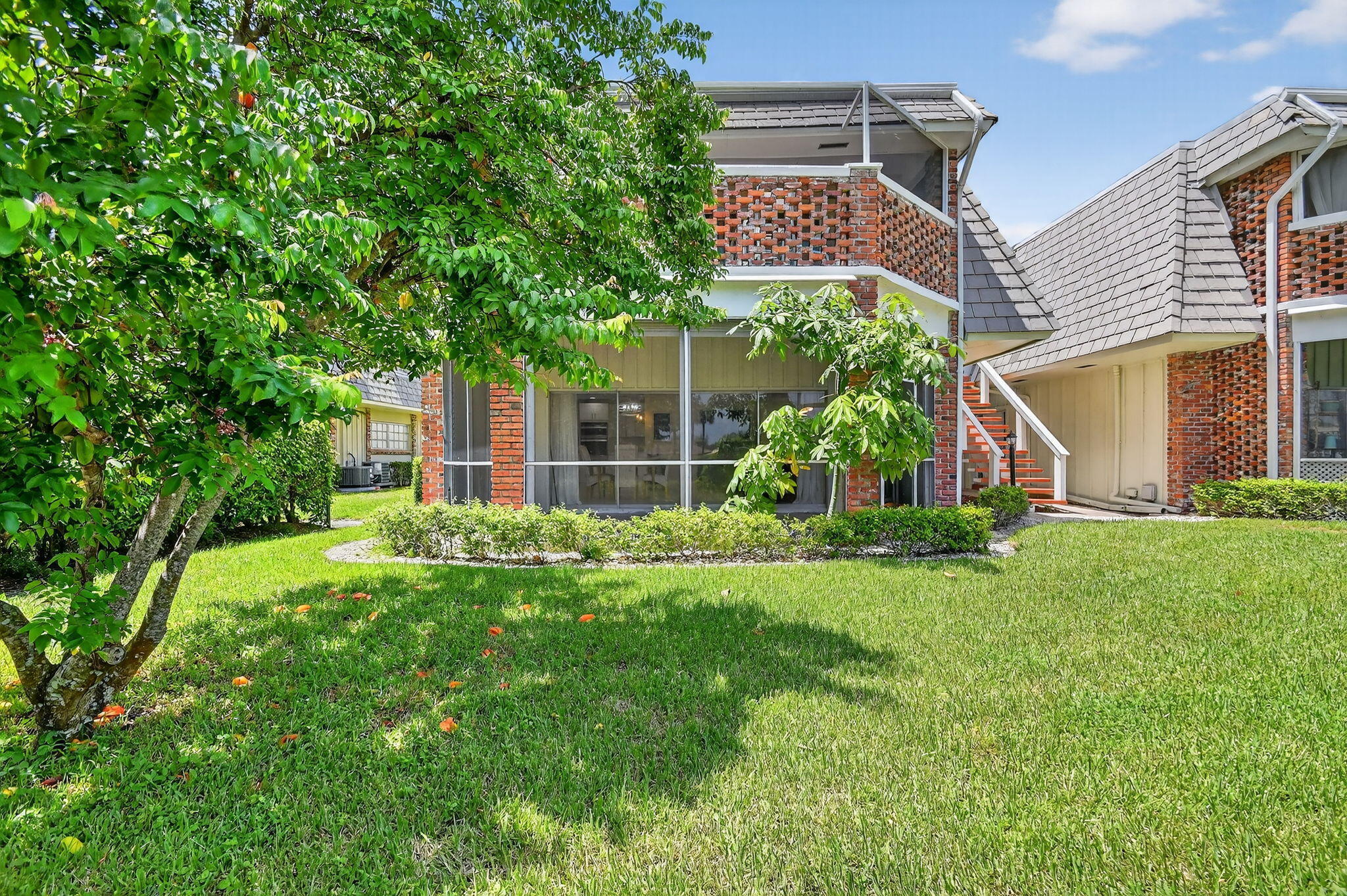 324 Orange Tree Drive, Unit 5 Atlantis, FL 33462 - Photo 21 of 29 a view of a house with a yard and sitting area