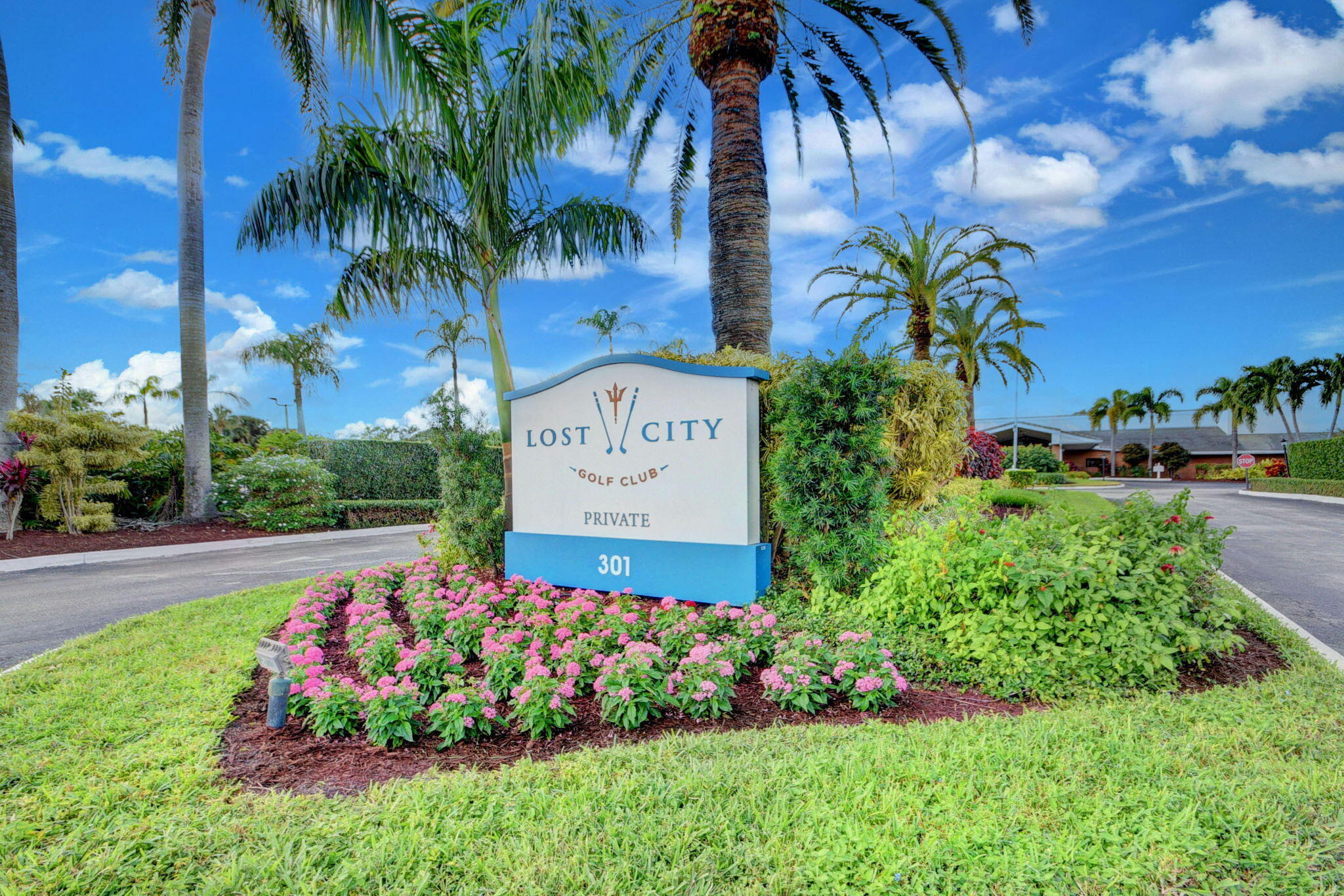 324 Orange Tree Drive, Unit 5 Atlantis, FL 33462 - Photo 27 of 29 a view of a garden with a building in the background