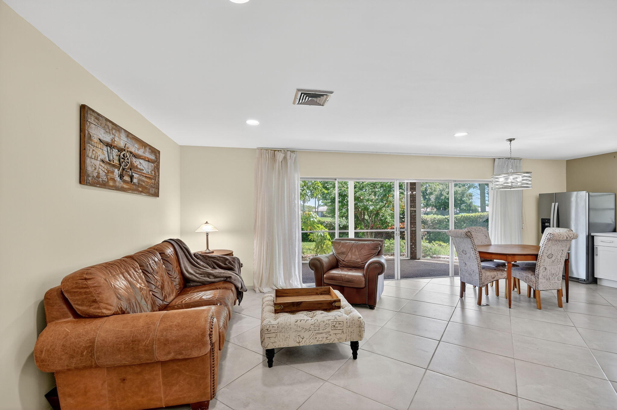 324 Orange Tree Drive, Unit 5 Atlantis, FL 33462 - Photo 3 of 29 a living room with furniture and a large window