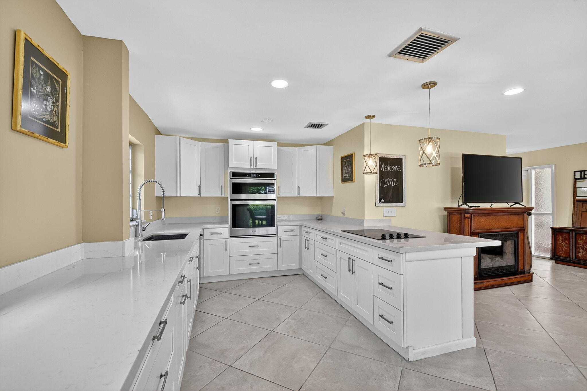 324 Orange Tree Drive, Unit 5 Atlantis, FL 33462 - Photo 6 of 29 a large white kitchen with cabinets