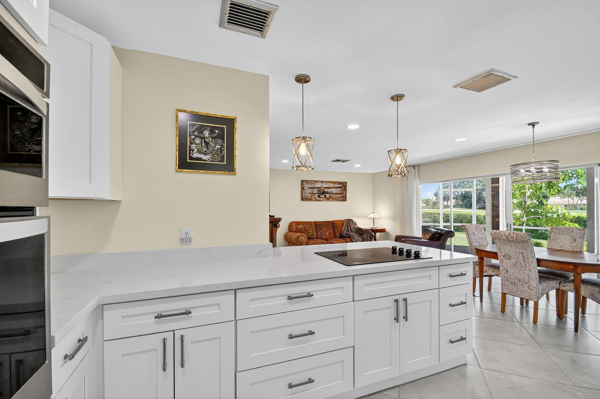 324 Orange Tree Drive, Unit 5 Atlantis, FL 33462 - Photo 7 of 29 a kitchen with white cabinets and a large window