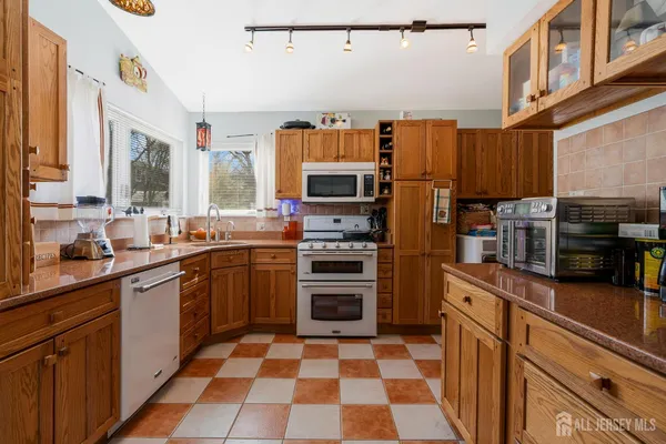 a kitchen with stainless steel appliances a stove sink and microwave