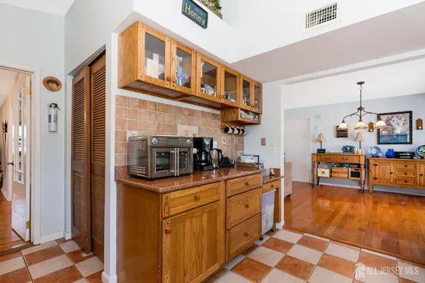 a kitchen with stainless steel appliances granite countertop a refrigerator and a stove