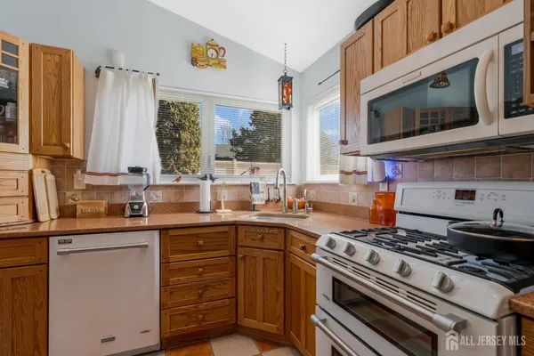 a kitchen with stainless steel appliances granite countertop a stove and a sink