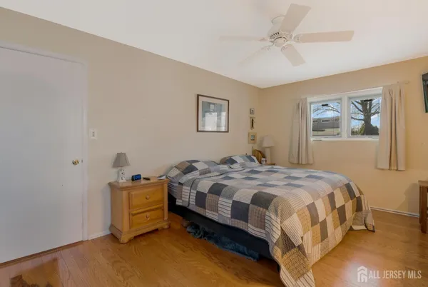 a bedroom with a bed and a painting on the wall