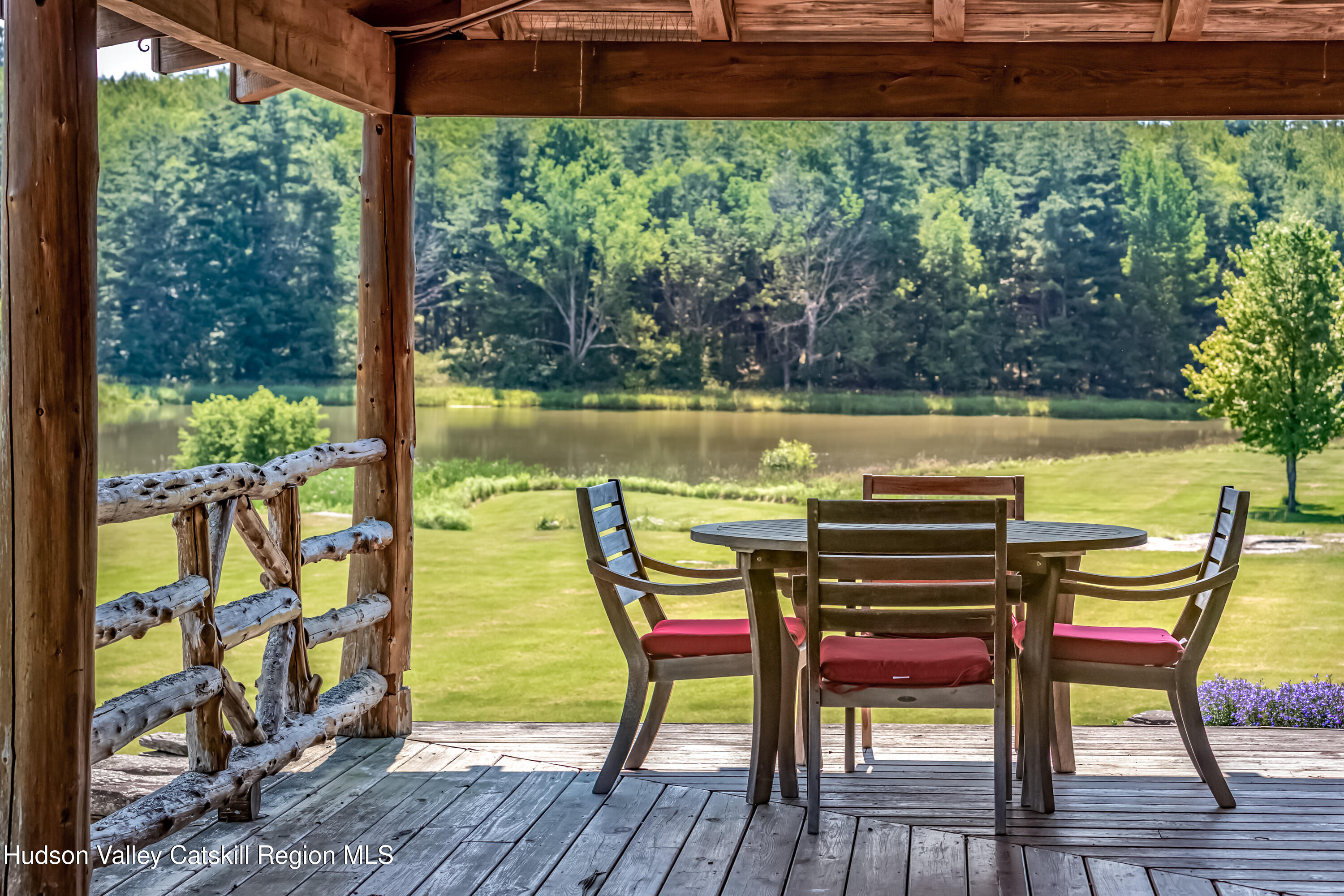 688 Bruce Porn Road Gilboa, NY 12167 - Photo 8 of 104 a view of a chairs and table in patio with a lake view