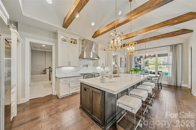 a kitchen with stainless steel appliances a stove a sink and a refrigerator
