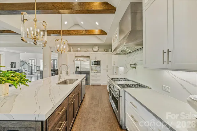a kitchen with stainless steel appliances a refrigerator and stove top oven
