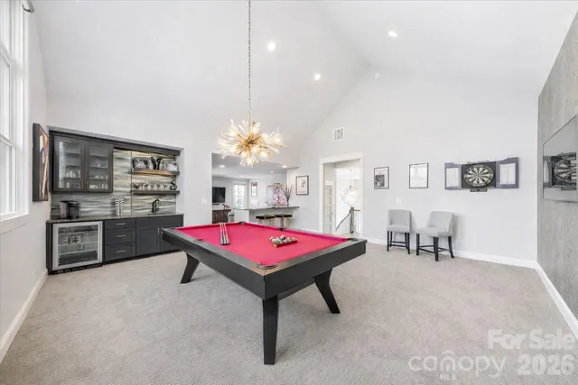 a view of a livingroom with dining room and wooden floor