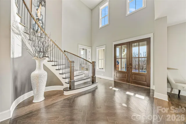 a view of entryway and hall with wooden floor