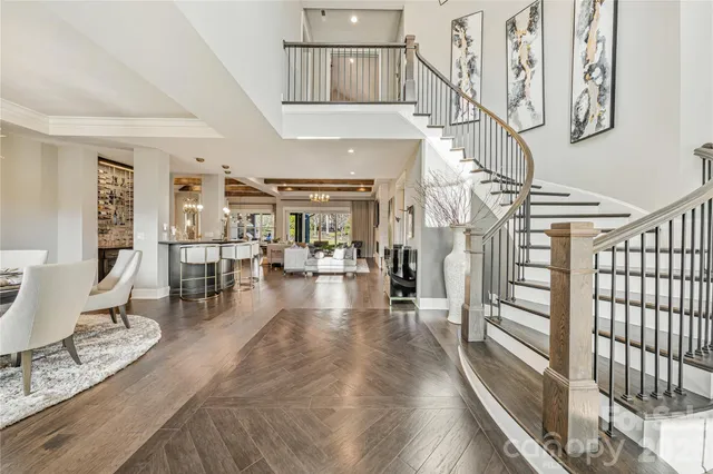 a view of a livingroom with furniture a fireplace wooden floor and a window