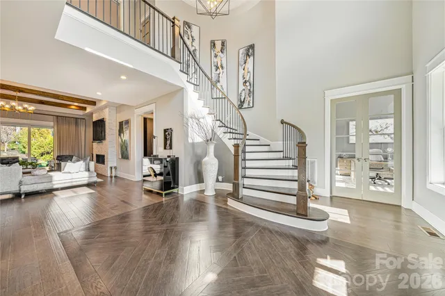 a kitchen with stainless steel appliances granite countertop a sink a counter space and living room view
