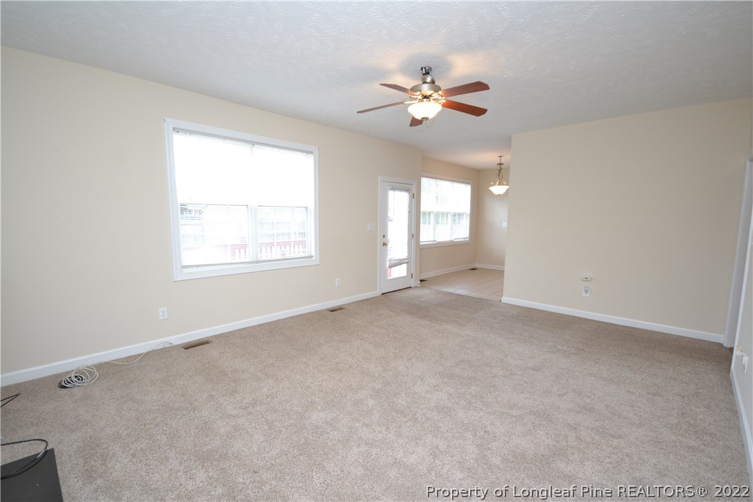 3608 Talus Road Fayetteville, NC 28306 - Photo 11 of 46 an empty room with windows and chandelier fan