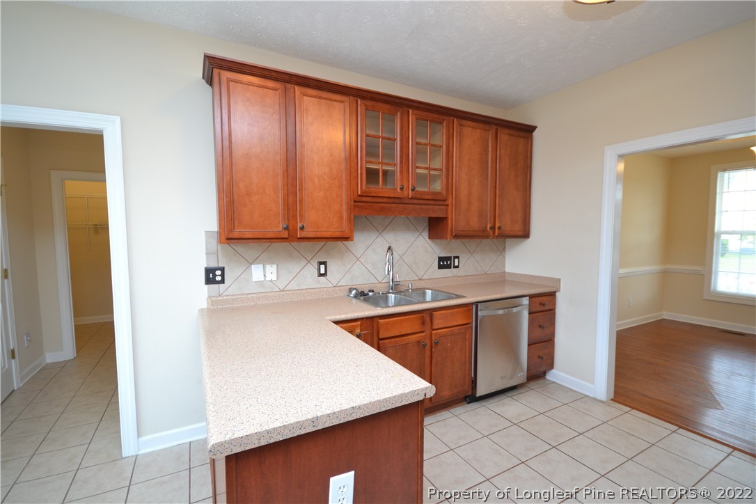 3608 Talus Road Fayetteville, NC 28306 - Photo 13 of 46 a kitchen with stainless steel appliances granite countertop a sink stove and refrigerator